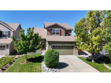 Charming two-story home featuring a well-manicured lawn and mature trees in a desirable neighborhood at 9255 Melborne Ct, Parker, CO 80134