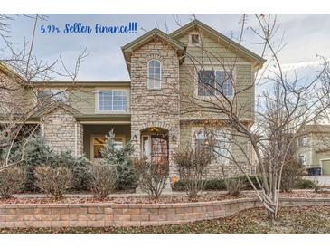 Two-story townhome with stone and siding exterior, landscaping, and walkway at 4508 E Louisiana Ave, Denver, CO 80246