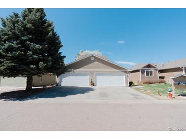 Home exterior features a two-car garage and landscaped front yard at 1225 Baker St, Longmont, CO 80501