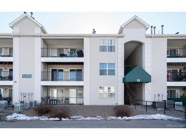 Three story condo building with balconies and an elevated walkway to the units at 12158 W Dorado Pl # 204, Littleton, CO 80127