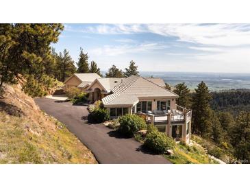 Stunning mountain home with a spacious deck and breathtaking views of the valley below at 1426 Rembrandt Rd, Boulder, CO 80302