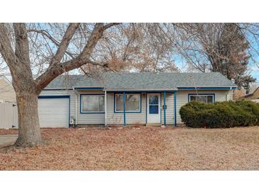 Ranch style home with attached garage and mature landscaping at 3052 S Grape Way, Denver, CO 80222