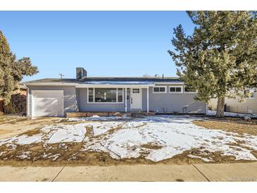 Newly remodeled home with a gray exterior, white door, and attached garage at 1040 Hoover Ave, Fort Lupton, CO 80621