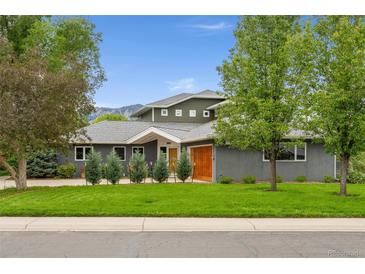Two story home with lush lawn, mature trees, and mountain views at 831 Crescent Dr, Boulder, CO 80303