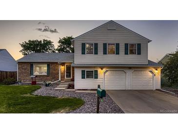 Charming two-story home with a well-maintained lawn, large driveway and attached two car garage at 7021 S Eudora St, Centennial, CO 80122