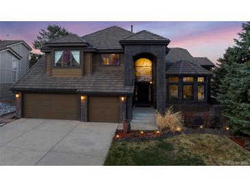 Stunning two-story home featuring a symmetrical facade, two-car garage, and beautiful desert landscaping at 34 Amaranth Dr, Littleton, CO 80127