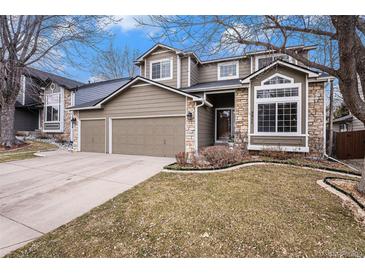 Charming two-story home featuring a two-car garage, stone accents and a well-manicured lawn at 5311 S Danube Ct, Centennial, CO 80015