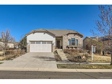 Charming single-story home featuring a stone facade and well-manicured front yard, perfect for curb appeal at 16494 Aliante Dr, Broomfield, CO 80023