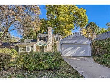 House exterior features a brick facade, attached garage and landscaping at 350 Cherry St, Denver, CO 80220