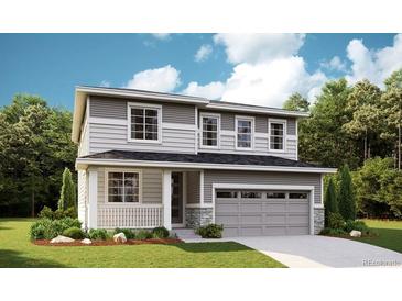 Beautiful two-story home featuring gray siding, stone accents, an attached two-car garage, and a welcoming front porch at 1354 Sienna Peak Cir, Erie, CO 80516