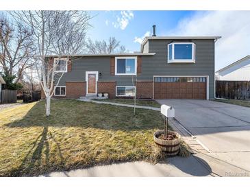 Charming two-story home with a well-maintained lawn and attached two-car garage in a quiet neighborhood at 1539 S Quail St, Denver, CO 80232