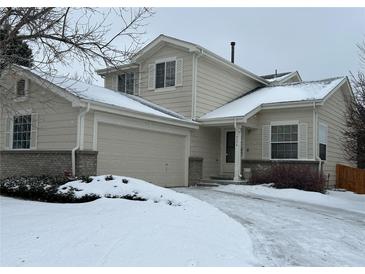 Charming two-story home with attached garage, snow-covered lawn, and inviting entrance at 18336 E Amherst Dr, Aurora, CO 80013