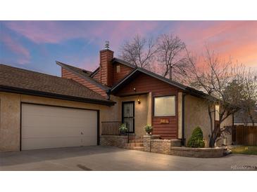 Charming home featuring a covered front porch, two car garage, and low-maintenance landscaping at 673 Brentwood St, Lakewood, CO 80214