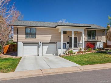 Charming home features a two car garage, lovely landscaping, and a quaint front entry at 9045 E Floyd Ave, Denver, CO 80231