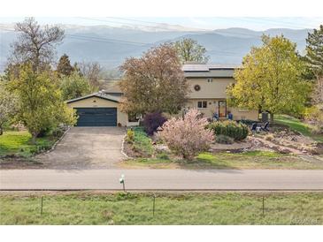 Inviting home with mature trees, landscaping, a two car garage and mountain views at 1069 Crestmoor Dr, Boulder, CO 80303
