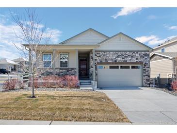 Charming single-Gathering home featuring a stone facade and two-car garage in a well-kept neighborhood at 6055 Point Rider Cir, Castle Rock, CO 80104