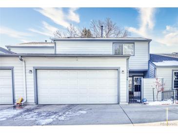Inviting two-story home showcasing a spacious two car garage, neutral siding, trimmed in gray, and a well manicured front yard at 14120 E Warren Pl, Aurora, CO 80014