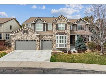 Beautiful two-story brick home featuring a three-car garage and well-maintained landscaping at 11930 E Lake Cir, Greenwood Village, CO 80111