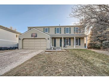 Two-story house with attached garage and nicely kept lawn at 1584 S Vaughn Cir, Aurora, CO 80012