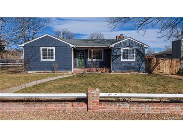 Charming Ranch style home with a newly painted exterior and well-manicured lawn at 7195 W 24Th Ave, Lakewood, CO 80214