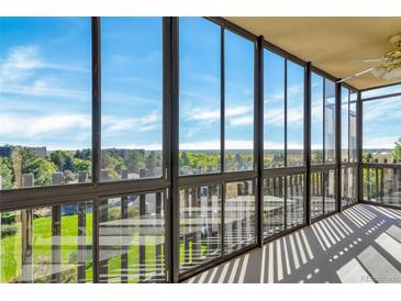 Bright sunroom featuring expansive glass windows offering panoramic views of the surrounding landscape at 14152 E Linvale Pl # 605, Aurora, CO 80014