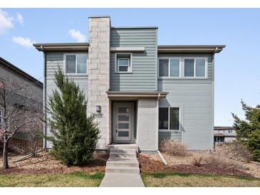 Contemporary two-story home featuring stone accents, modern siding, and a well-manicured front yard at 3368 Cranston Cir, Highlands Ranch, CO 80126