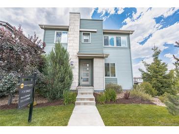 Charming two-story home with a well-manicured lawn and inviting stone-accented entrance at 3368 Cranston Cir, Highlands Ranch, CO 80126