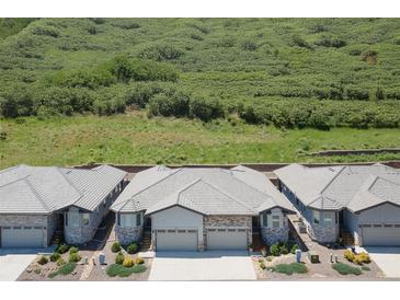 View of the beautiful home exterior with a well-maintained roof and landscaping at 6835 Surrey Trl, Littleton, CO 80125