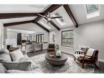 Open-concept living room features vaulted ceilings and seamless flow at 11861 E Yale Ct, Aurora, CO 80014