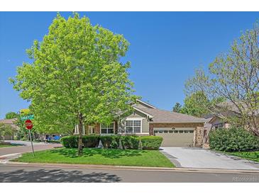 Charming single Gathering home with stone accents, a well-manicured lawn, and mature trees at 6673 S Benton St, Littleton, CO 80123