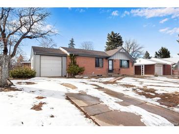 Brick ranch home with attached garage and snowy front yard at 153 S Pierce St, Lakewood, CO 80226