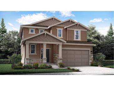 Two-story house with brown siding, stone accents, and a two-car garage at 210 Paloma Way, Elizabeth, CO 80107