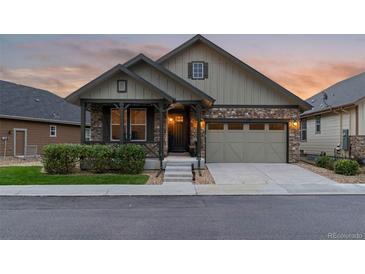 Charming single-Gathering home featuring stone accents, a covered porch, and a well-maintained front yard at 6597 Club Villa Rd, Parker, CO 80134