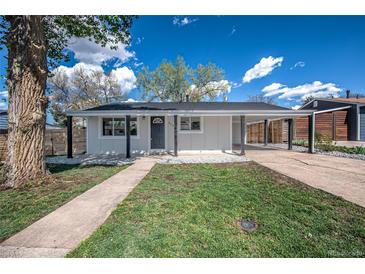 Charming home with a well-maintained front yard and a covered carport at 3940 S Hazel Ct, Englewood, CO 80110