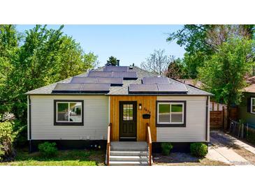 Charming home featuring solar panels, updated siding and front door, plus fresh landscaping at 3636 Ames St, Wheat Ridge, CO 80212