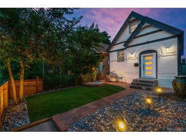 Charming home with a brick walkway, rock landscaping, and a well-maintained lawn at 720 Lipan St, Denver, CO 80204