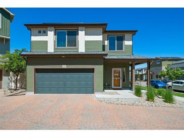 Charming two-story home with a front garage and a welcoming entrance with pleasant, easy-to-maintain landscaping at 19120 E 54Th Pl, Denver, CO 80249
