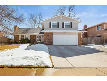 Charming two-story home with a well-maintained lawn, showcasing its classic architecture and welcoming curb appeal at 7862 W Euclid Pl, Littleton, CO 80123