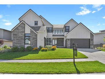 Beautiful two-story home featuring modern architecture, stone accents, and well-manicured landscaping in a great location at 2230 Rim Ridge Dr, Castle Pines, CO 80108