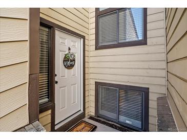 Welcoming front door with decorative wreath and covered entrance at 1161 S Marshall St, Lakewood, CO 80232