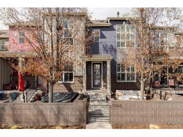 Charming townhouse showcasing a stylish brick facade, covered patio, and inviting outdoor seating area, perfect for relaxing at 10065 Martin Luther King Blvd, Denver, CO 80238