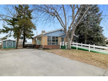 Ranch style home with a spacious yard and attached garage at 11040 Emerson St, Northglenn, CO 80233