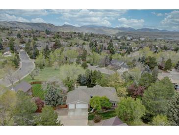 Expansive aerial view of the home and surrounding neighborhood with mountain backdrop at 13959 W Cedar Pl, Golden, CO 80401