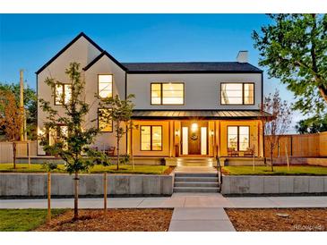 Inviting two-story home with a well-manicured lawn and a charming covered porch at 4520 W Moncrieff Pl, Denver, CO 80212