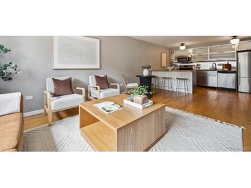 Inviting living room featuring hardwood floors, stylish seating, and a bright, open layout at 75 N Emerson St # 104, Denver, CO 80218