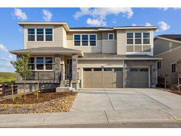 Two-story home with a three-car garage and modern stonework accents at 8601 Yellowcress St, Littleton, CO 80125