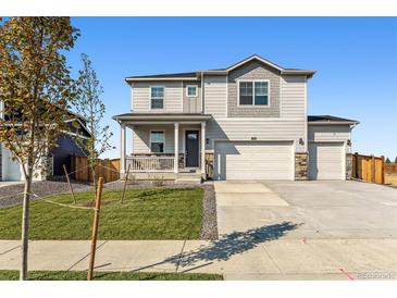 Charming two-story home with a welcoming front porch and a well-manicured lawn at 4635 Cattle Cross Trl, Castle Rock, CO 80104