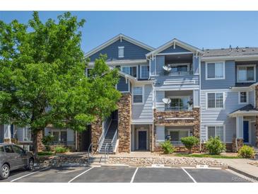 Attractive exterior of townhome with stone accents, covered patios, and dedicated parking spots at 5255 Memphis St # 811, Denver, CO 80239