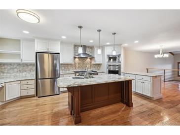 Spacious kitchen featuring stainless steel appliances, granite countertops, and a central island at 2609 S Quebec S St # 20, Denver, CO 80231