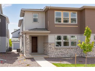 Charming two-story home featuring stone accents and a well-manicured front yard for great curb appeal at 1415 Great Western Dr, Longmont, CO 80501